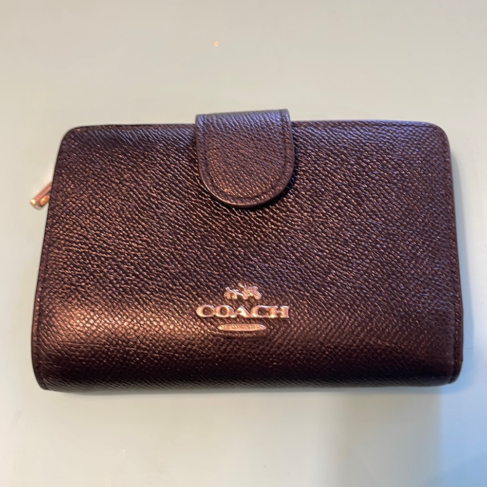 Black textured leather Coach Wallet with silver hardware.